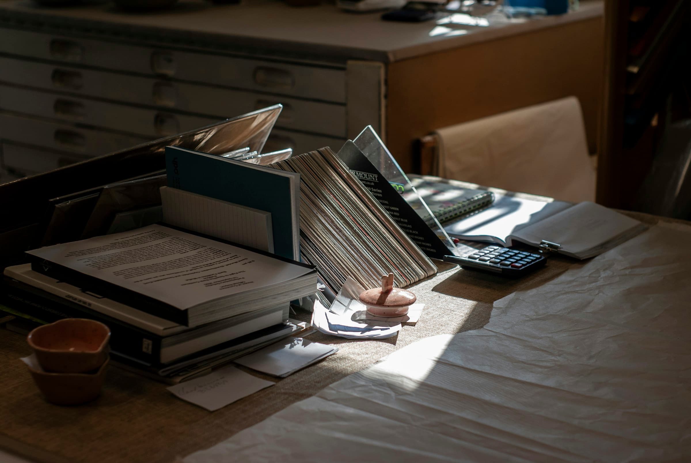 Documents, folders and a calculator on a desk